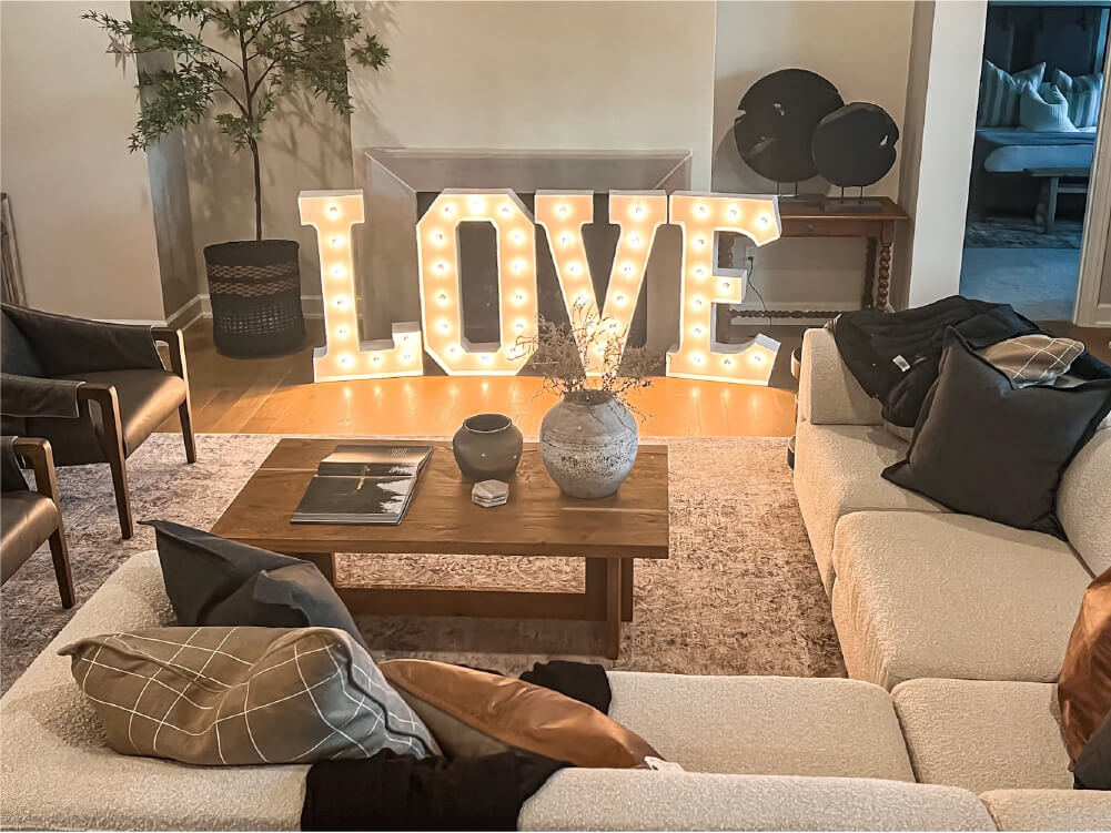 The word 'love' in marquee letters with white bulbs as a center piece in the living room