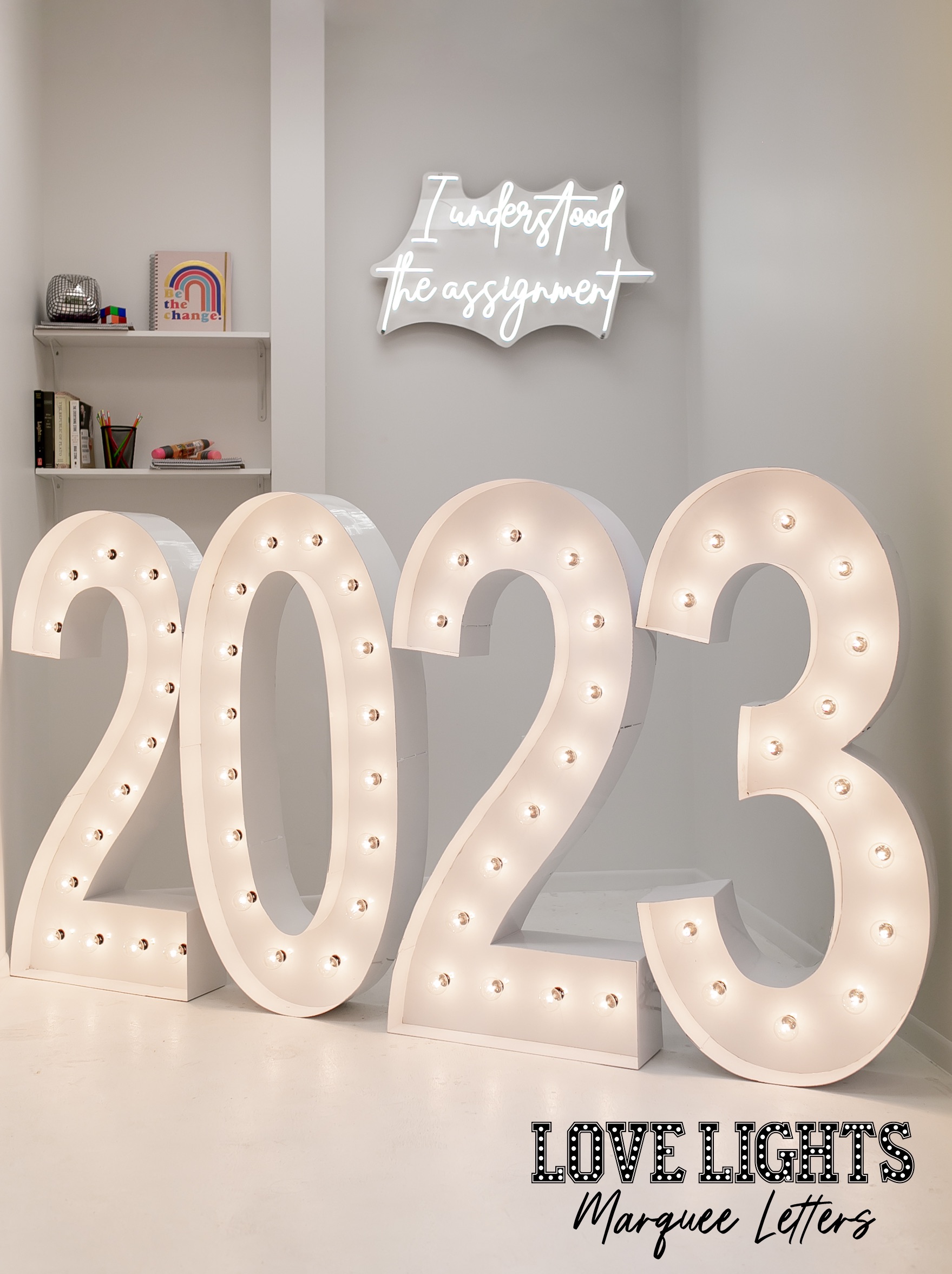 2023 in lit marquee letters in a white room with LED light saying I understood the assignment