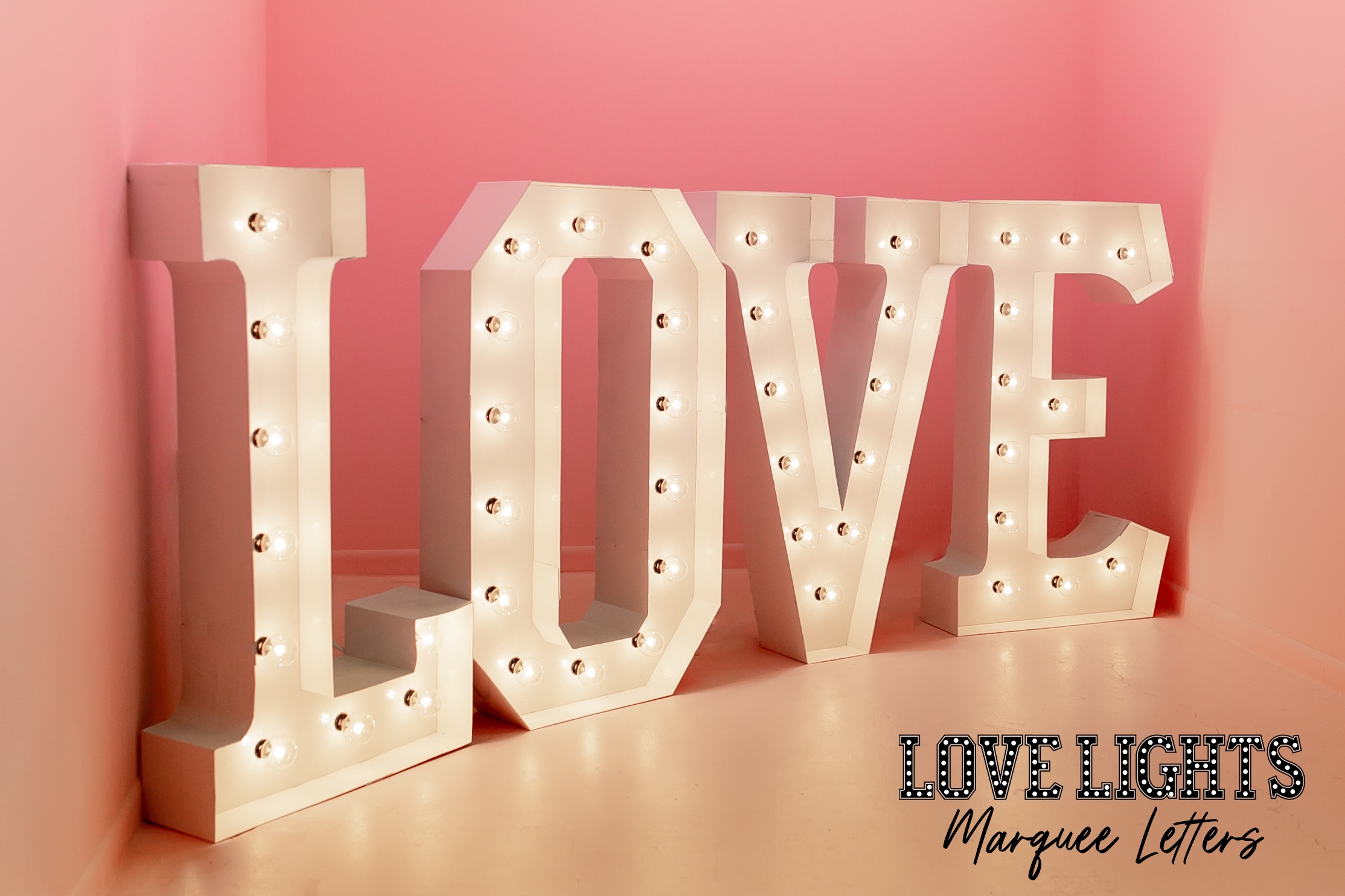love in lit marquee letters in pink room