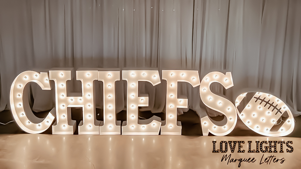 Chiefs in lit marquee letters with a football in lit marquee letters