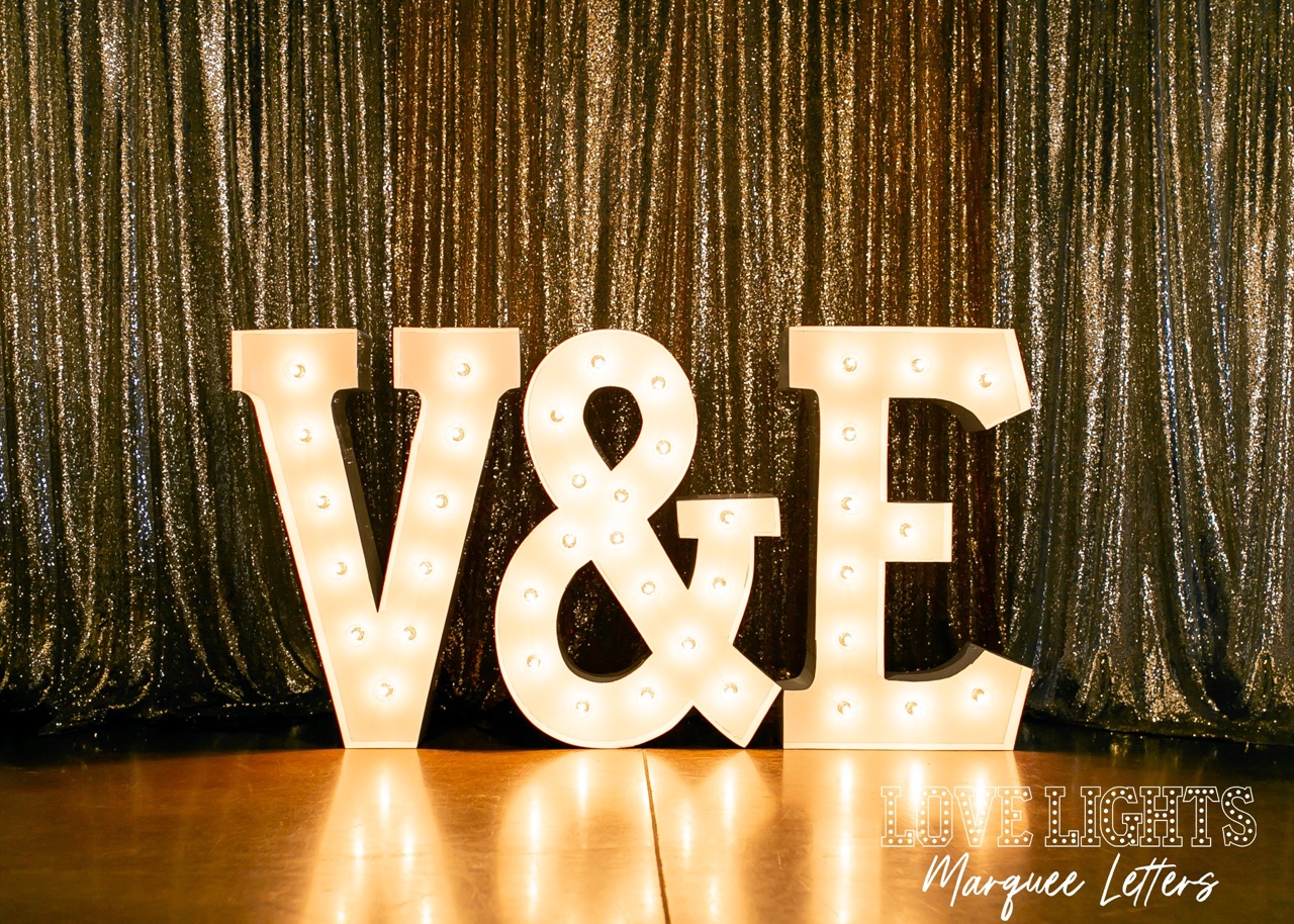 V&E in lit marquee letters